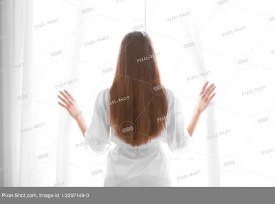 Девушка смотрит в бинокль через окно - Фотография - PerfectStock