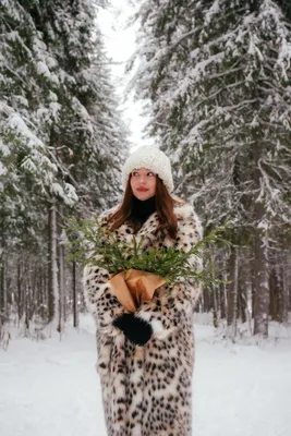 милая и красивая девушка брюнетка стоит возле елки зимой в парке на  природе, на ветвях лежит снег, девушка одета в длинное платье и шубу Stock  Photo | Adobe Stock