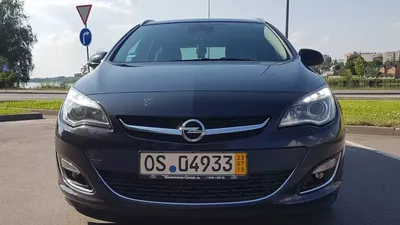 Opel astra j sportstourer from 2012 in dark blue with widebody and spoiler  on Craiyon