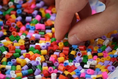 Assorted colors of Ikea Pyssla thermo-mosaic beads in a transparent  container, selective focus Stock Photo - Alamy