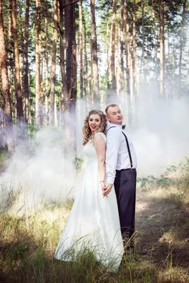 Bride and groom with a bright red smoke Stock Photo by ©meatbull 89866232