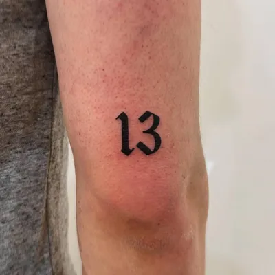 Lucky 13 tattoo on the wrist.